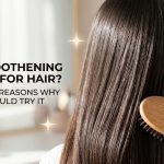A woman with sleek, shiny, and perfectly smooth hair looking over her shoulder, demonstrating the results of a keratin treatment.