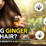 Fresh ginger roots and a bottle of ginger-infused hair oil sitting on a wooden table next to a green plant.