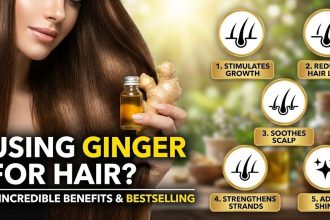 Fresh ginger roots and a bottle of ginger-infused hair oil sitting on a wooden table next to a green plant.